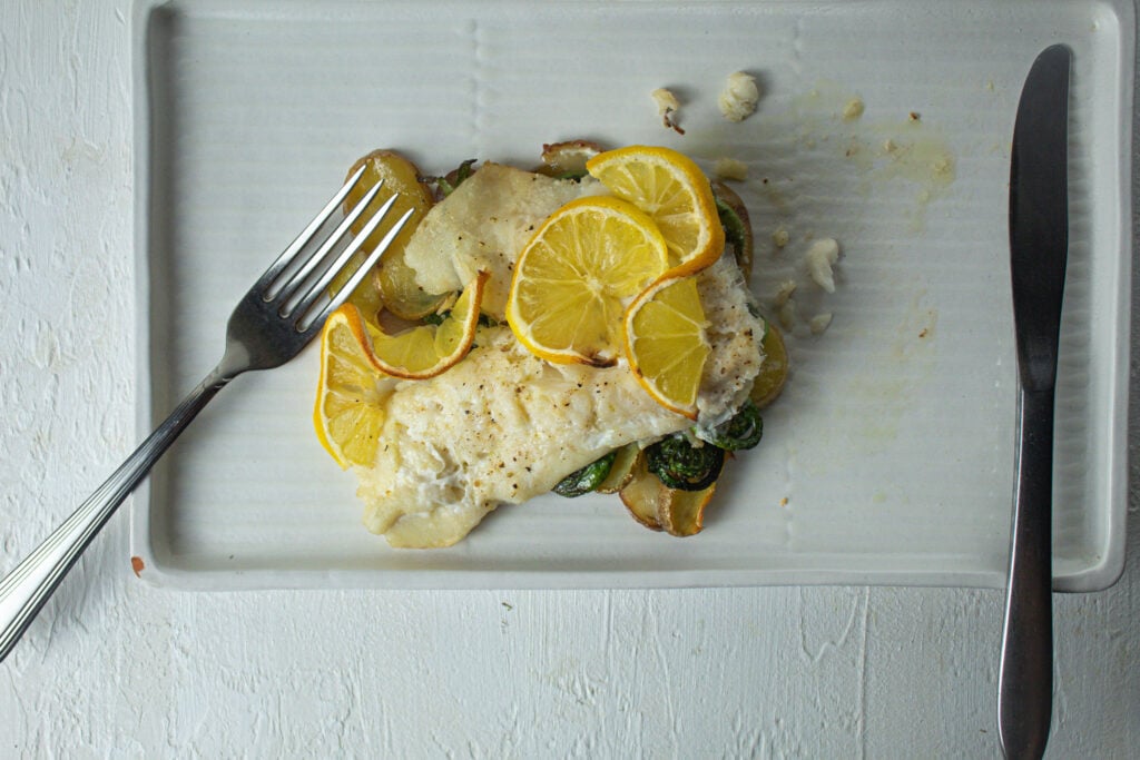 baked haddock fillet with fiddlehead ferns.