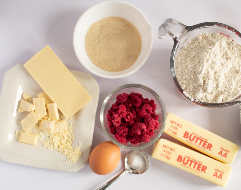 ingredients for cookies, flour, butter sticks, raspberries, egg
