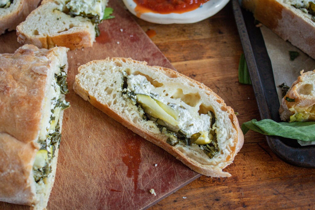 ramp and zucchini calzone on cutting board.