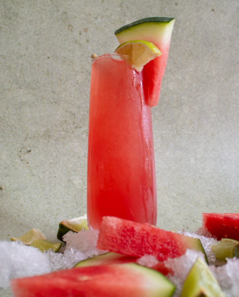 watermelon coconut cooler with ice and watermelon slices surrounding