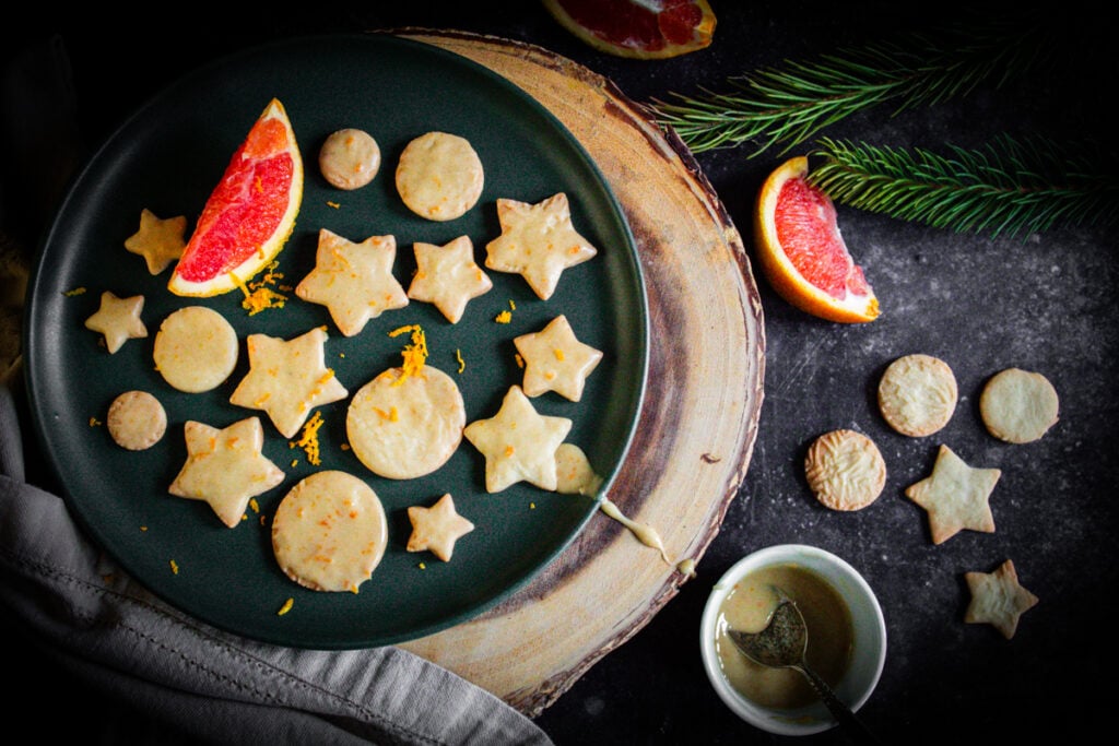 ginger orange cookies with sliced oranges on dark background