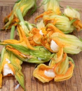a pile of stuffed squash blossoms ready to be coated with flour before frying.