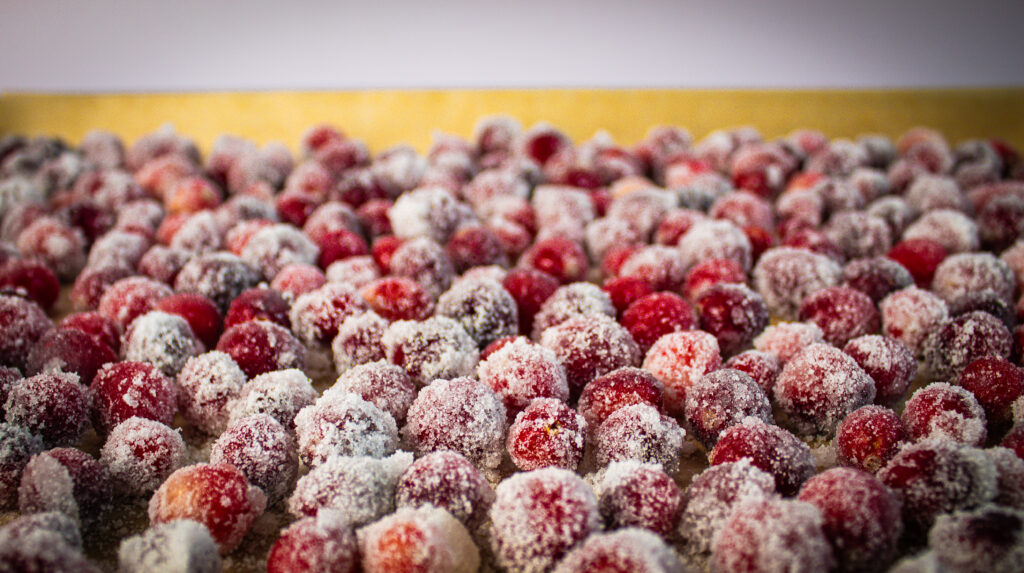 sugar coated cranberries on baking sheet.