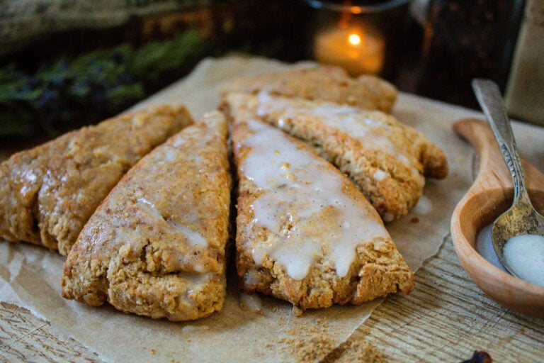 Iced gingerbread scones on wooden cutting board.