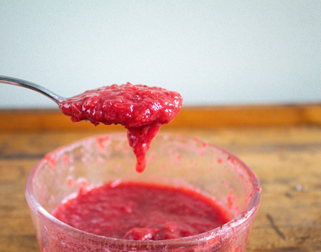 Spoonful of stewed fruit showing soft texture.