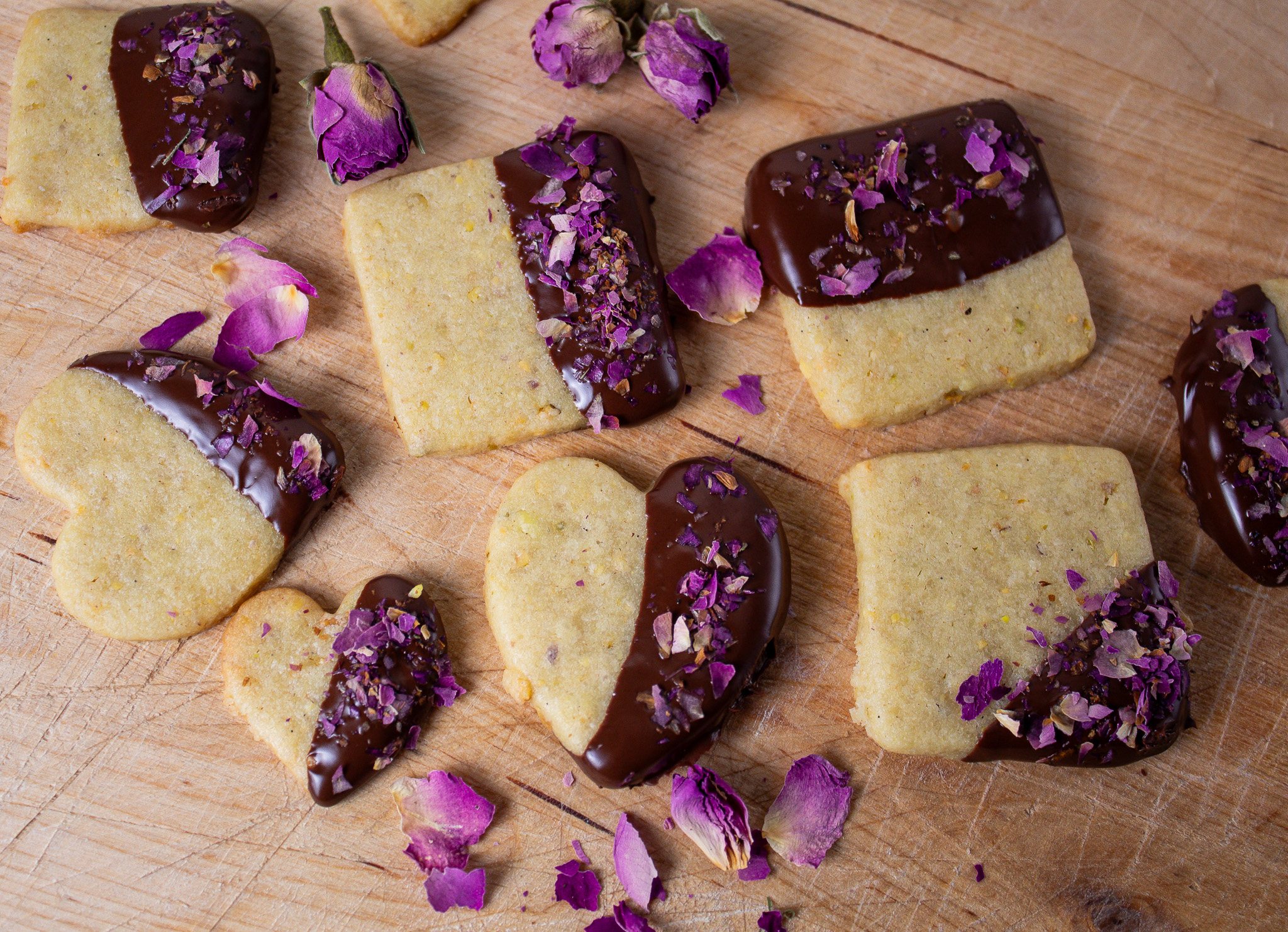 choclate dipped pistachio cookies sprinkled with rose petals.