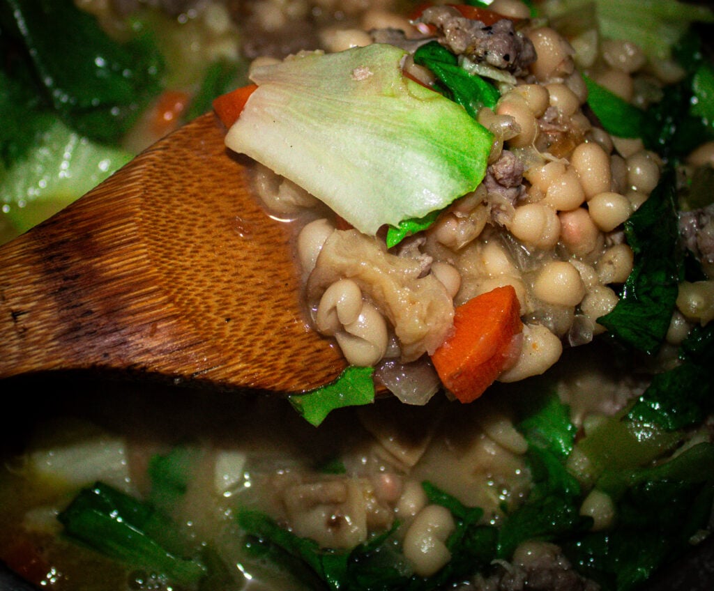 white bean and escarole soup with sausage, mushrooms and hazelnuts.