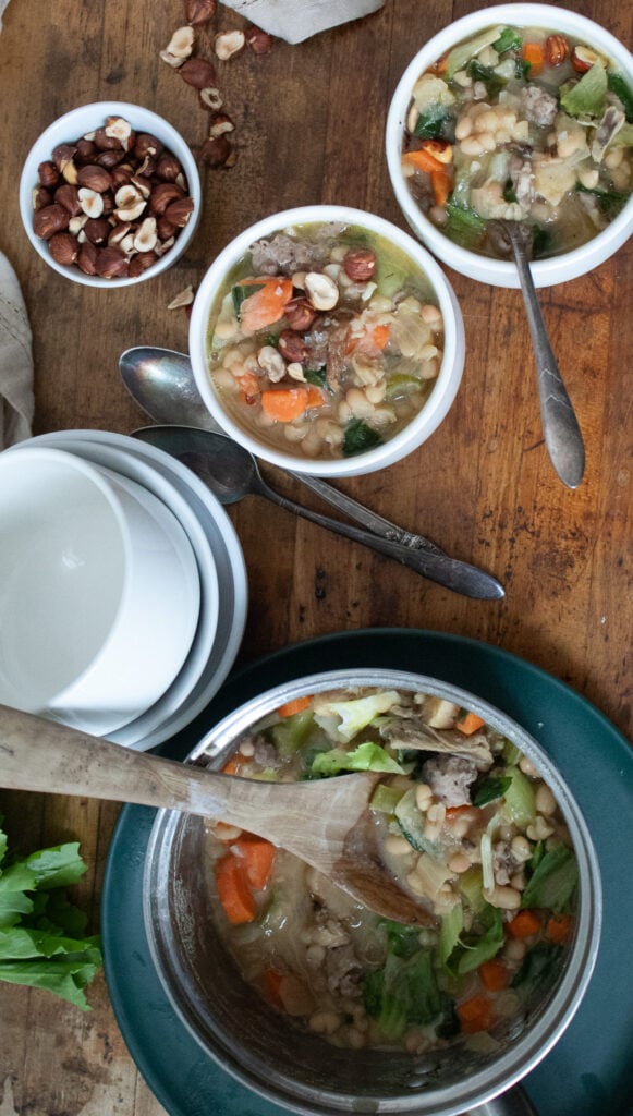 white bean and escarole soup with sausage, mushrooms and hazelnuts.