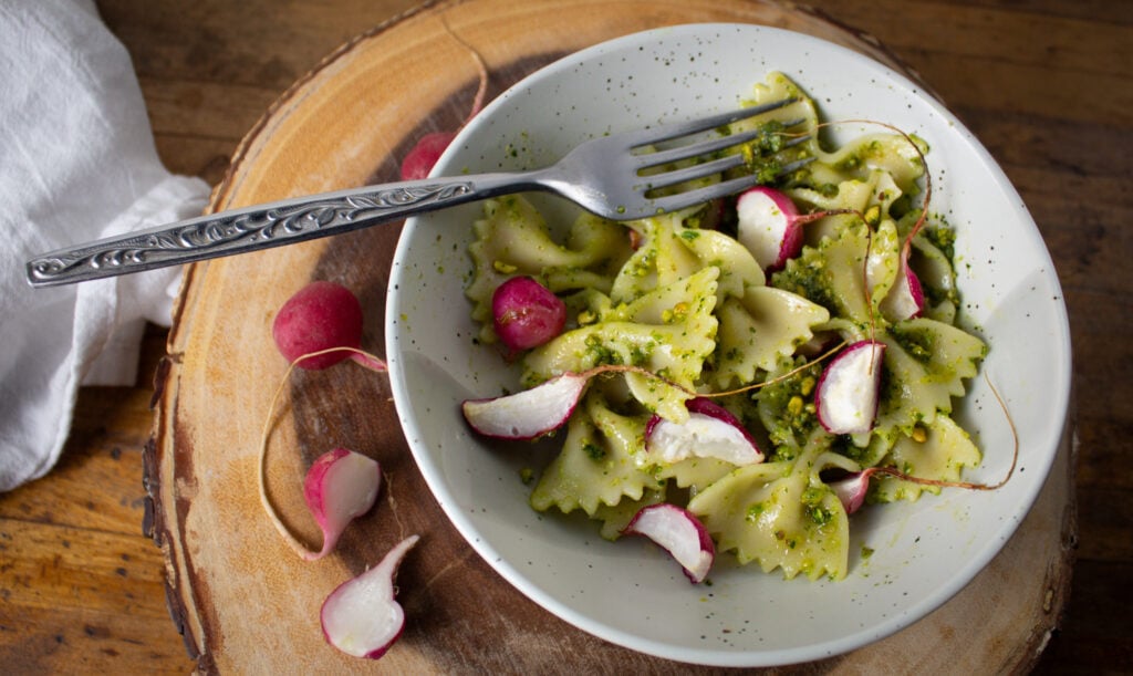 farfalle pasta with pea shoot pesto and roasted radishes. 