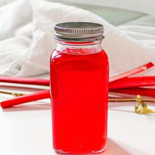 rhubarb simple syrup with ginger in glass jar.