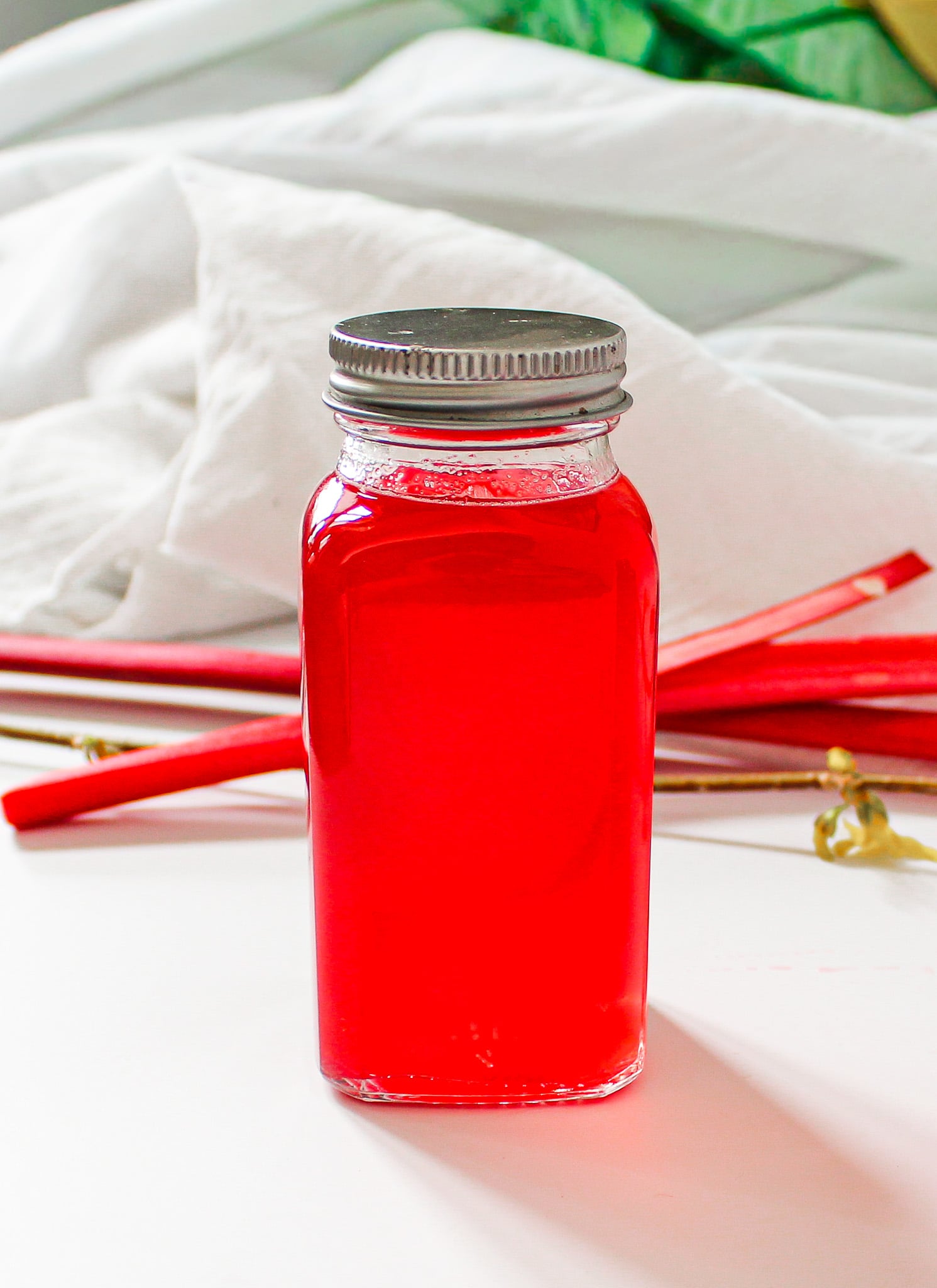 rhubarb simple syrup with ginger in glass jar.