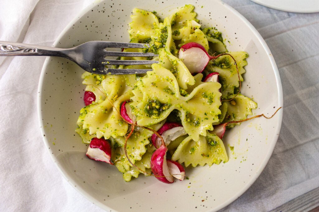 bowtie pasta with pea shoot pesto and roasted radishes.