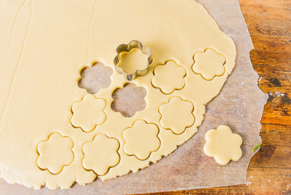 meyer lemon cookie dough rolled out with cookie cutter.