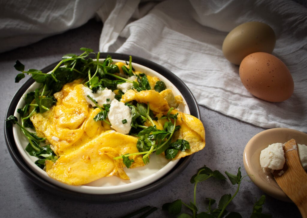 soft scrambled eggs with wilted pea shoots, goat cheese and chives for breakfast.