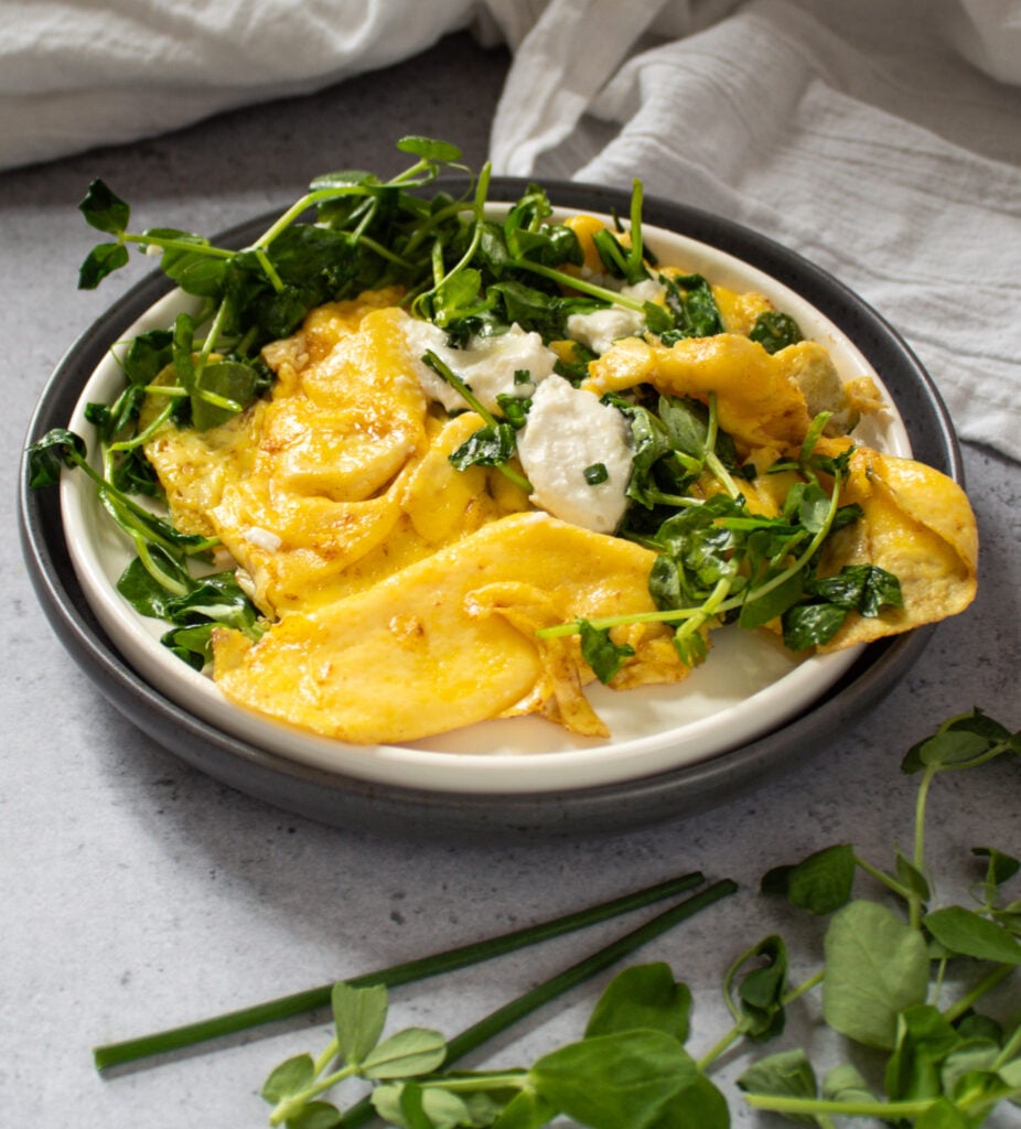 soft scrambled eggs with pea shoots and goat cheese.
