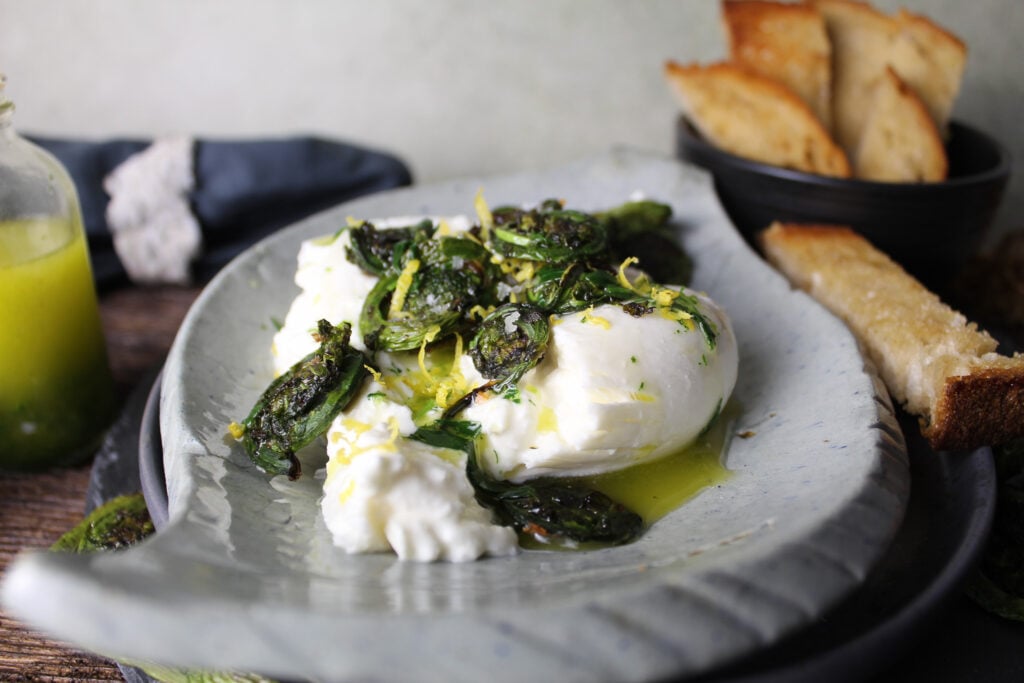 Grilled Fiddleheads with Burrata and Tarragon Oil.